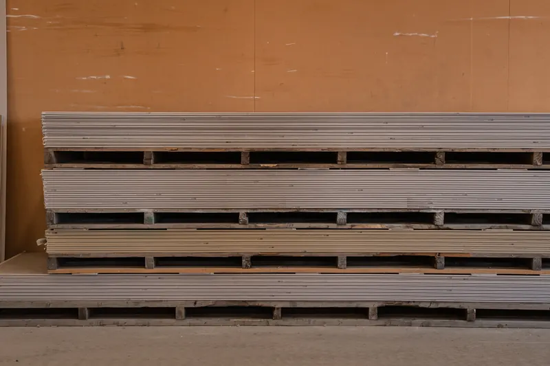 Stacks of flat sheet board on bearers inside the BuildLink Timaru warehouse