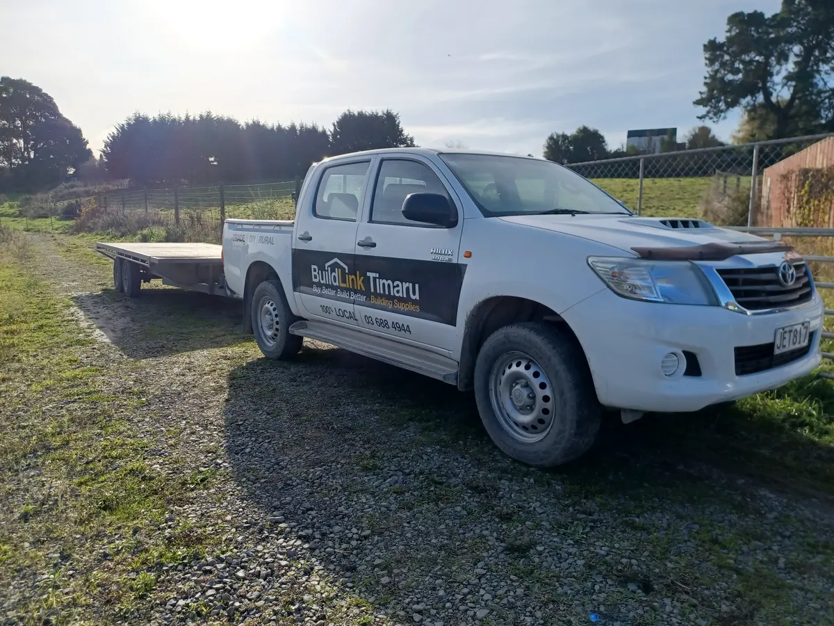 The BuildLink Timaru ute hitched to a flat deck trailer