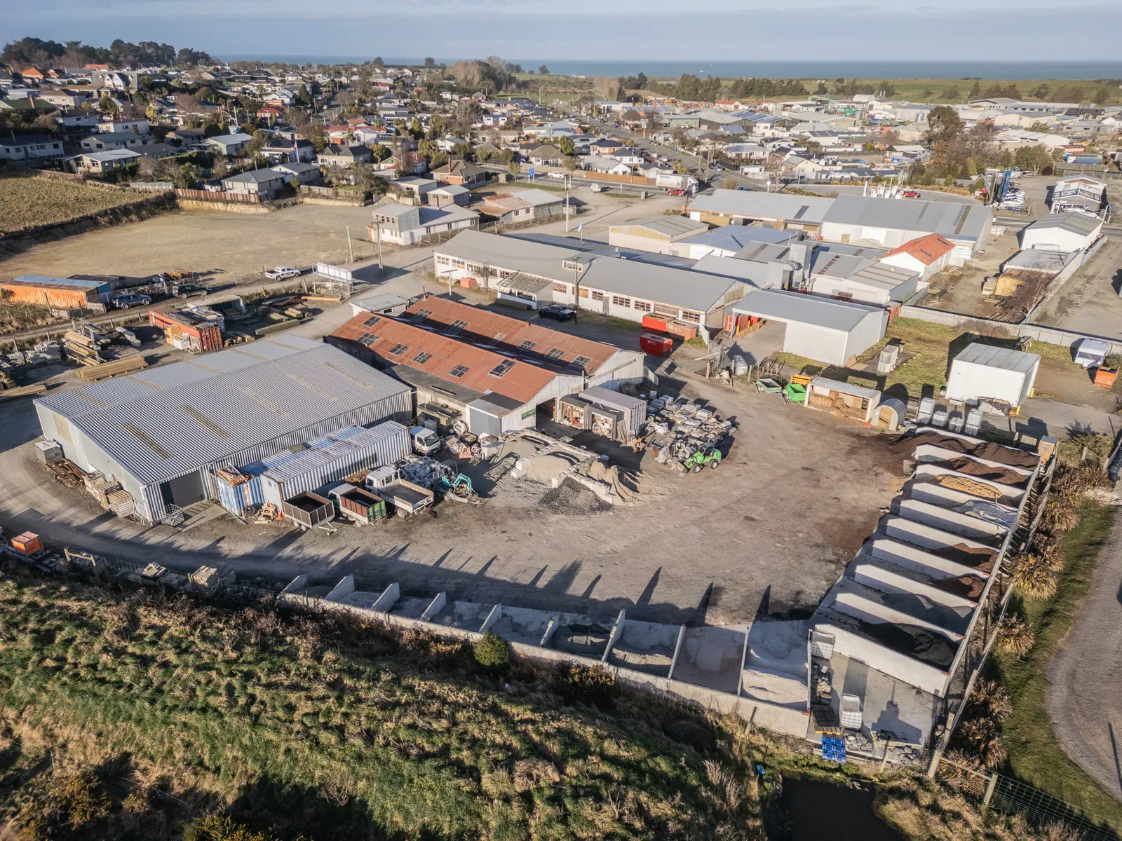 The BuildLink Timaru yard on King Street from the air, with Timaru and the coast behind it