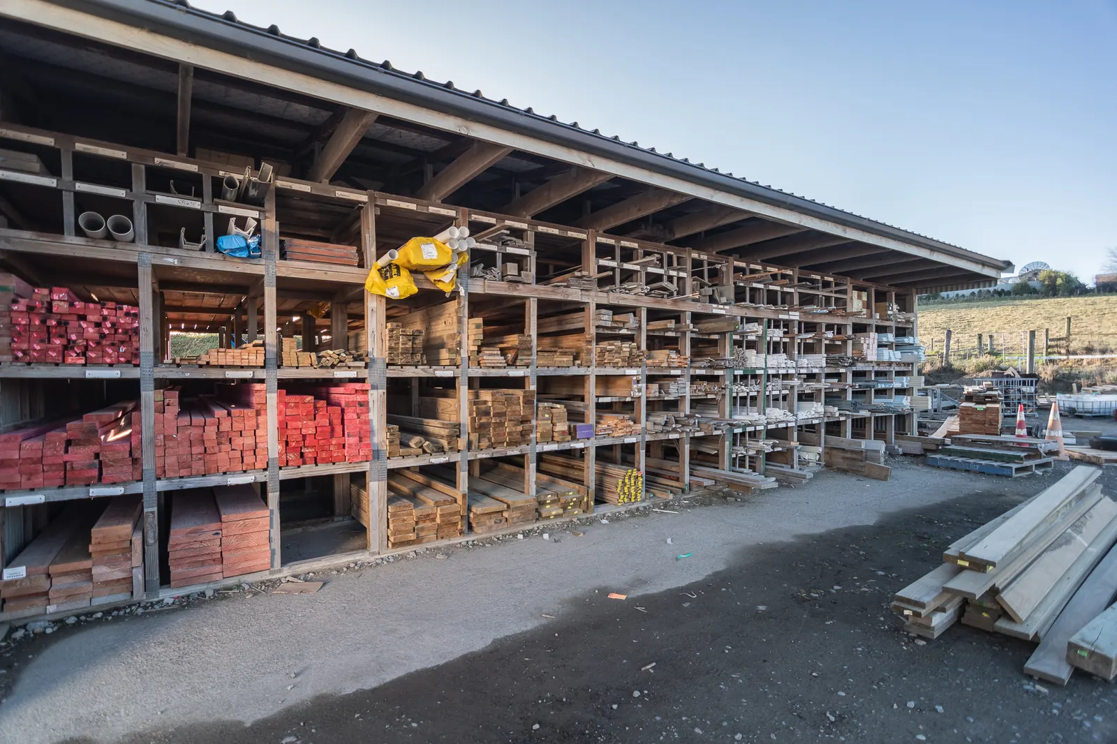 Open-fronted timber racks at BuildLink Timaru, loaded with treated timber and framing stock